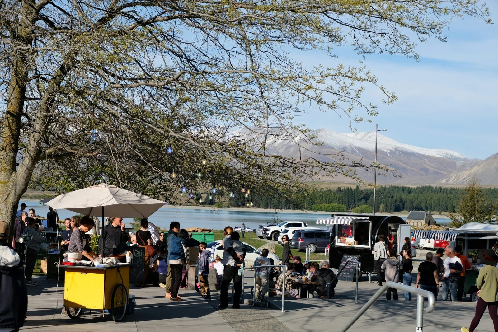 a group of people standing around a yellow cart