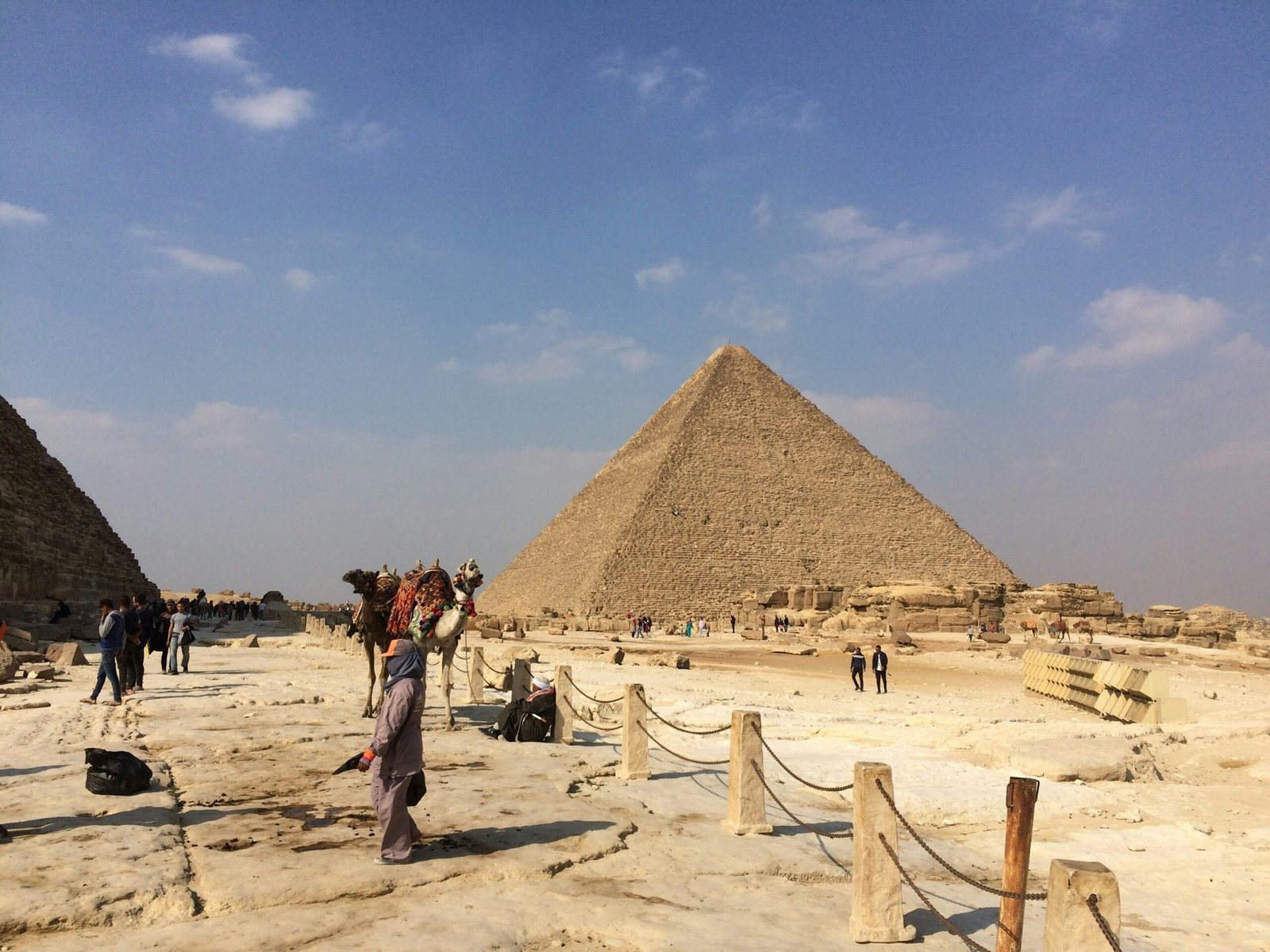 people standing near Pyramid of Giza under blue and white sky at during daytime